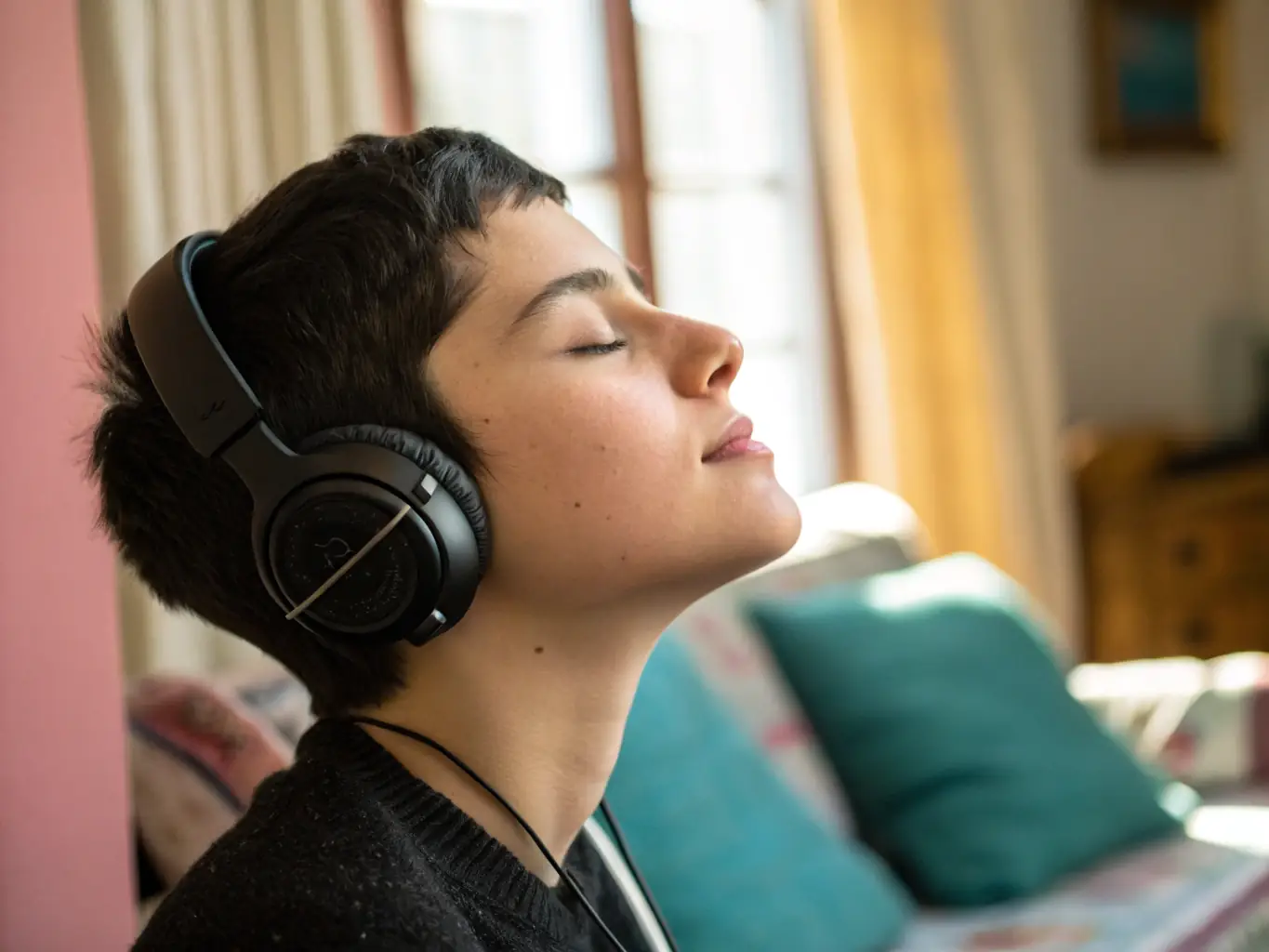 A serene image of a person listening to music with eyes closed, surrounded by calming colors, representing emotional regulation through music.